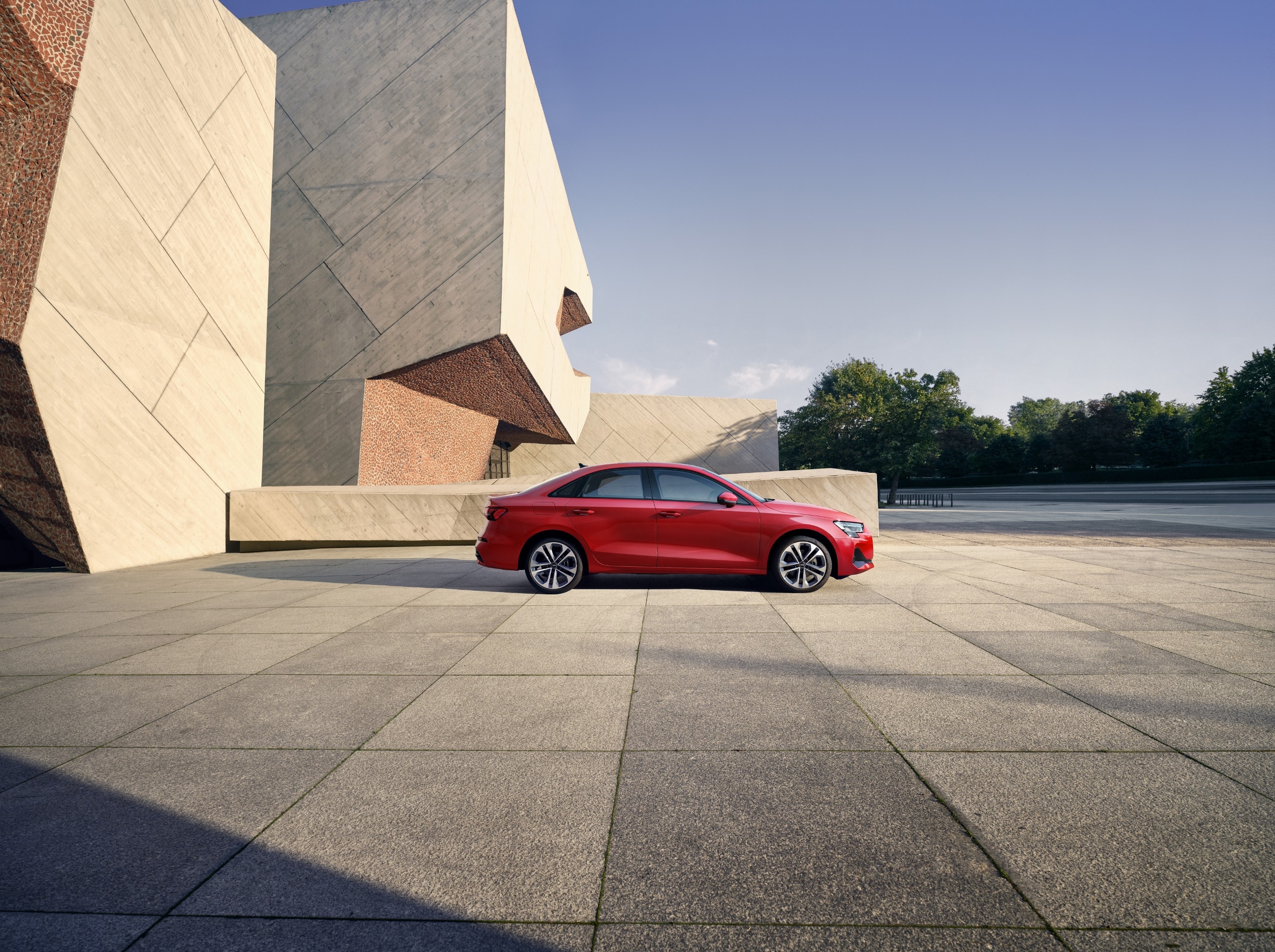 A red car parked in front of a building

Description automatically generated