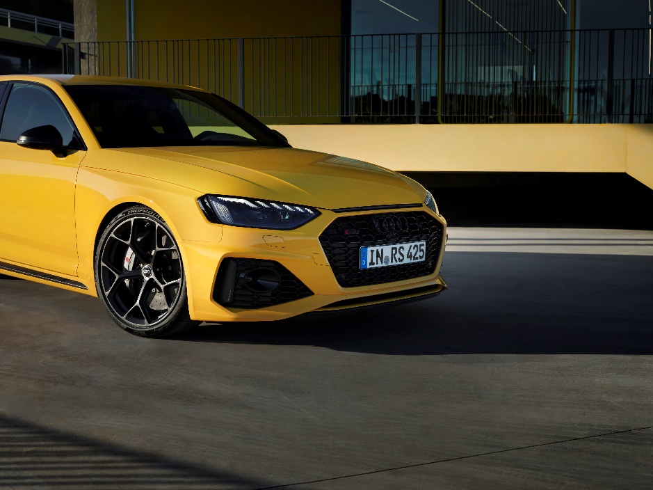 A yellow car parked in front of a building

Description automatically generated